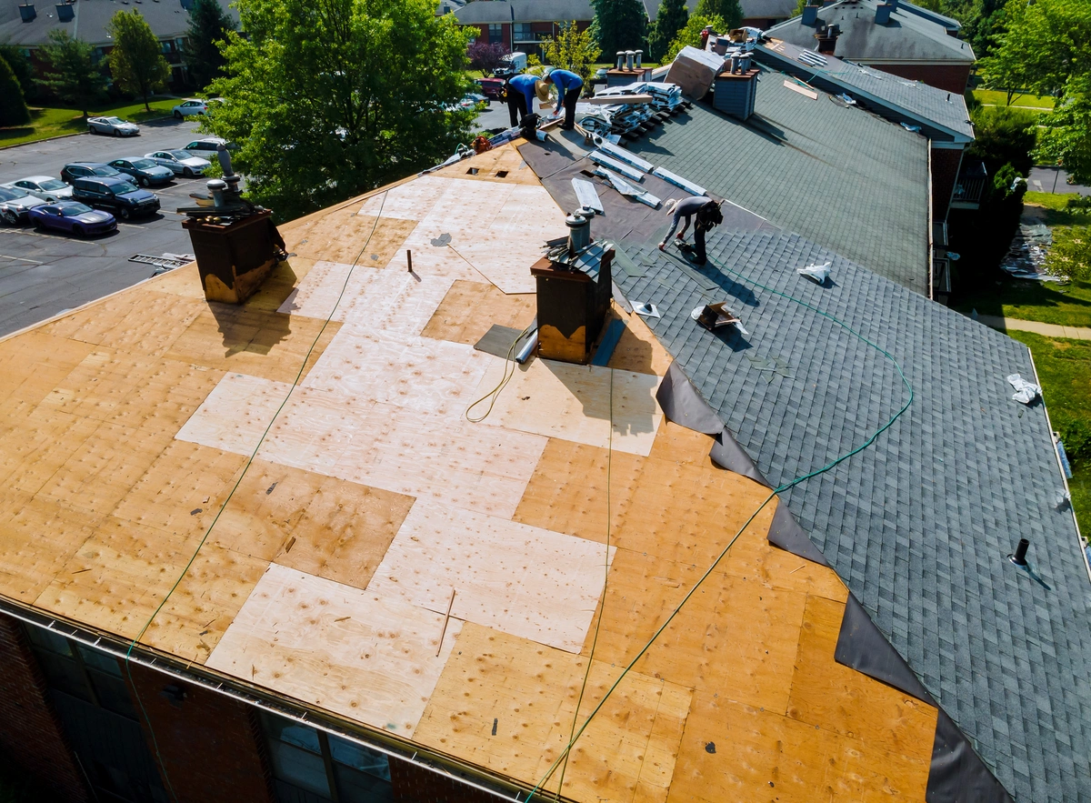 Professional roofer showing shingles to homeowner
